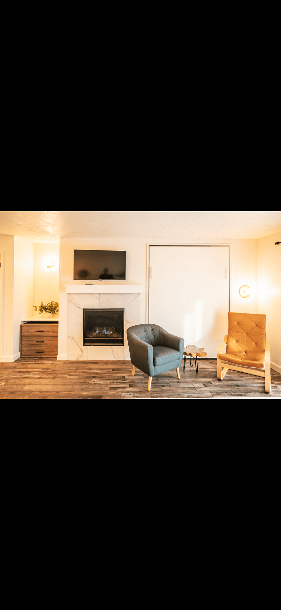Fireplace and fold up Murphy bed for guests in living room 