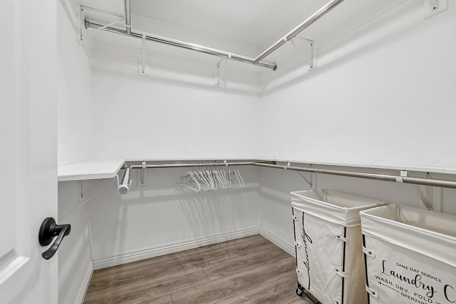Primary bedroom walk in closet