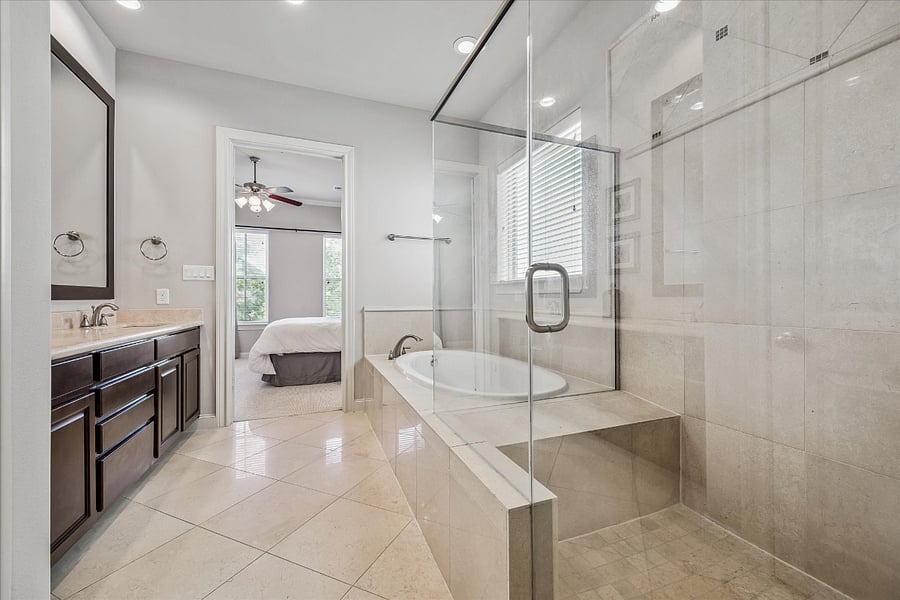 Primary bathroom with walk-in shower and separate soaking tub. 