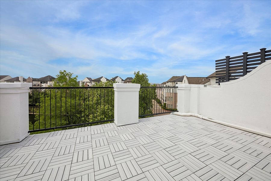 Rooftop deck, with new decking, overlooks the community lake and swimming pool. 