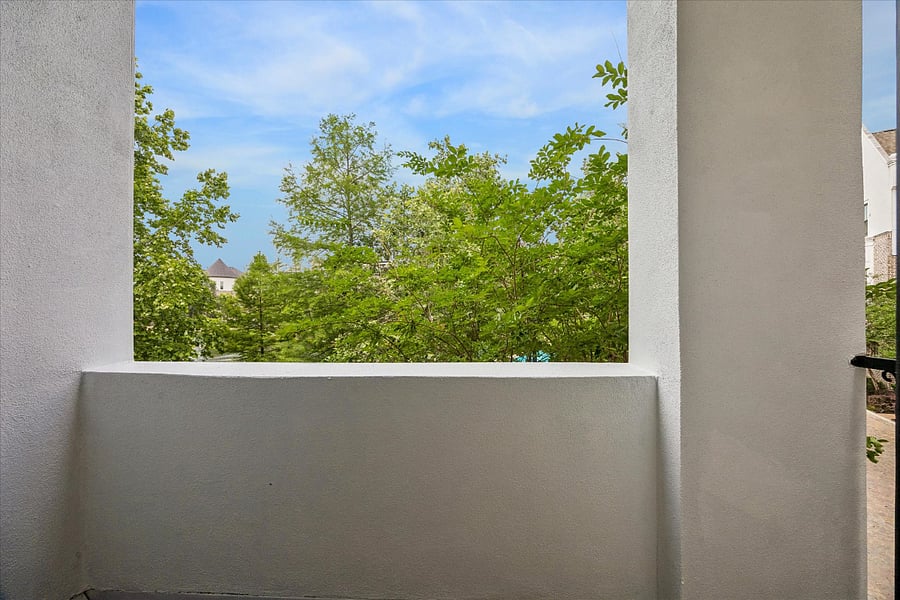 Second floor balcony, located outside of the living room, overlooks the community lake and swimming pool.