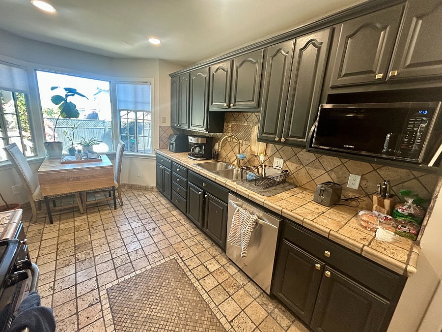 Full size kitchen with kitchen table and chairs.