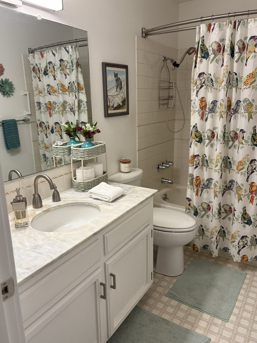 Your private bathroom includes fresh towels, a hair dryer, grab bars, generous storage, and thoughtful amenities to help you feel at home.