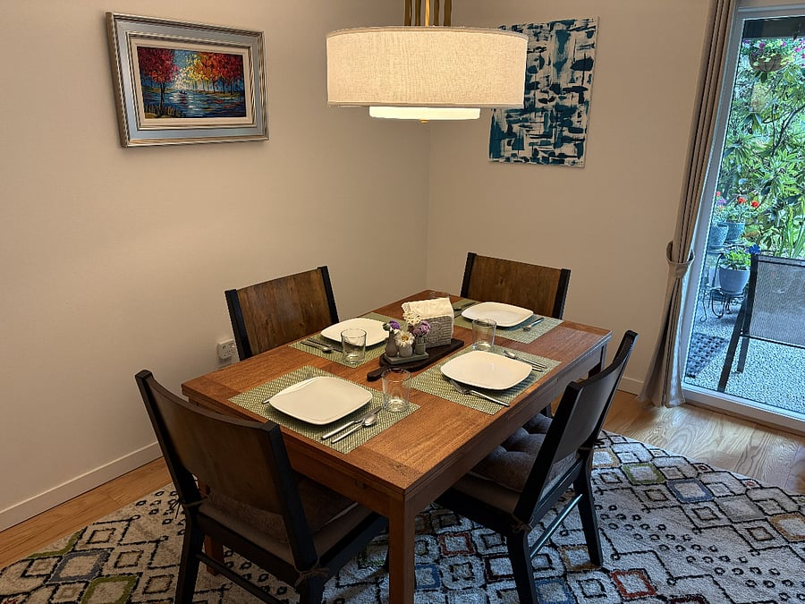 The dining table comfortably seats four. For a quick meal or morning coffee, three swivel bar stools at the kitchen counter offer another comfortable place to dine.