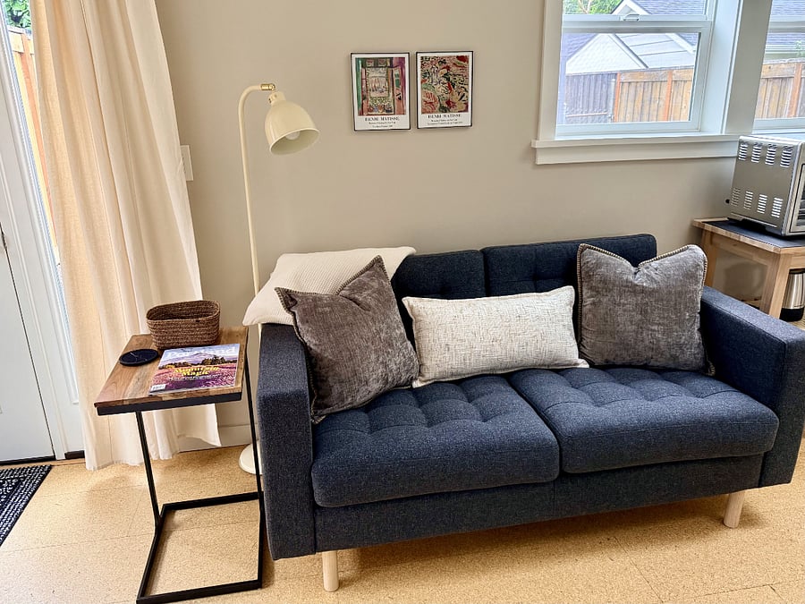 Comfy couch with side table that can be moved for easy laptop or eating table.