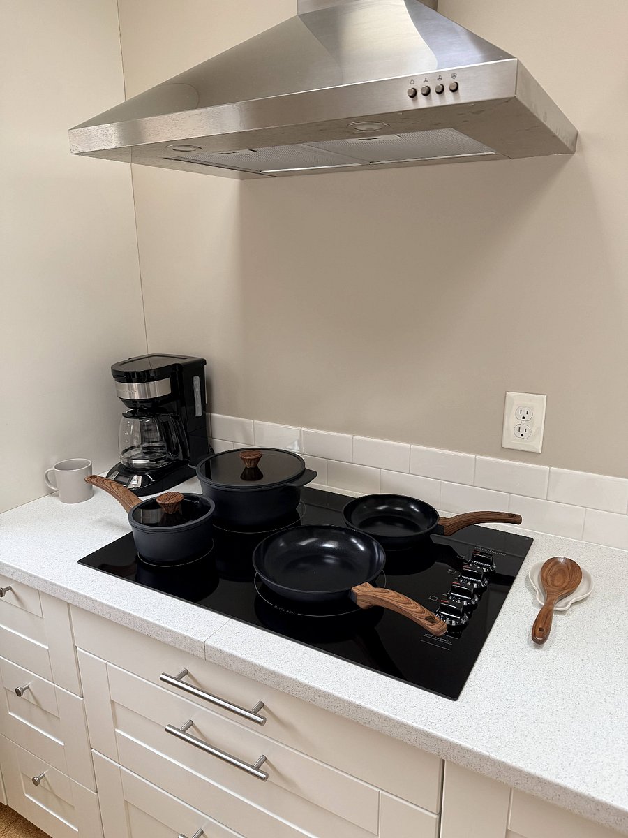 Kitchen with brand new electric cooktop and coffee maker.
