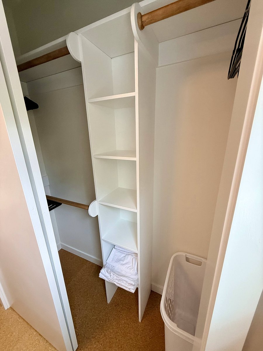 Separate closet with 3 hanging rods and shelves for extra storage.
