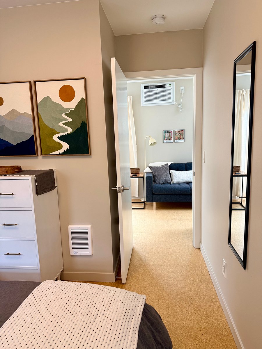 View from bedroom into living room, where wall-unit A/C is located to keep the entire home cool.