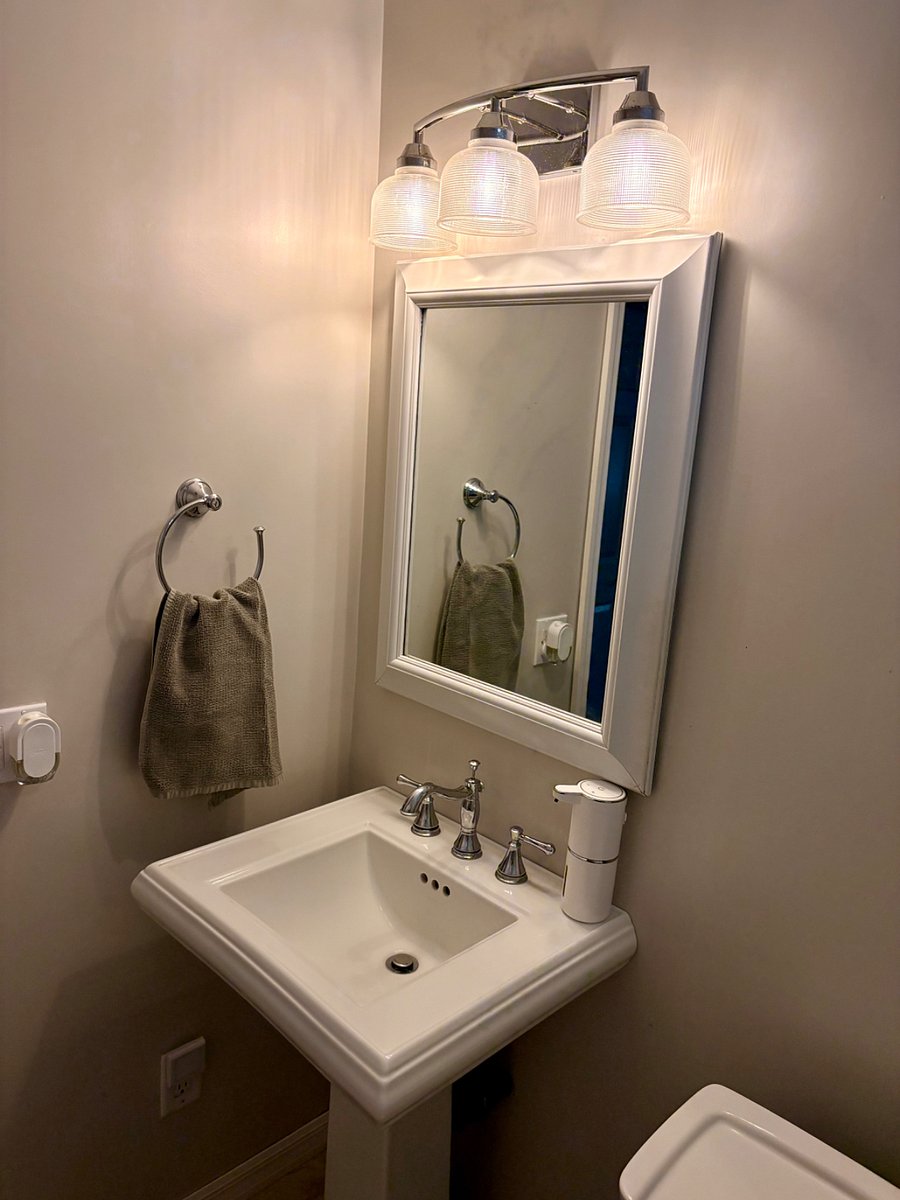 Pedestal sink with bathroom cabinet.