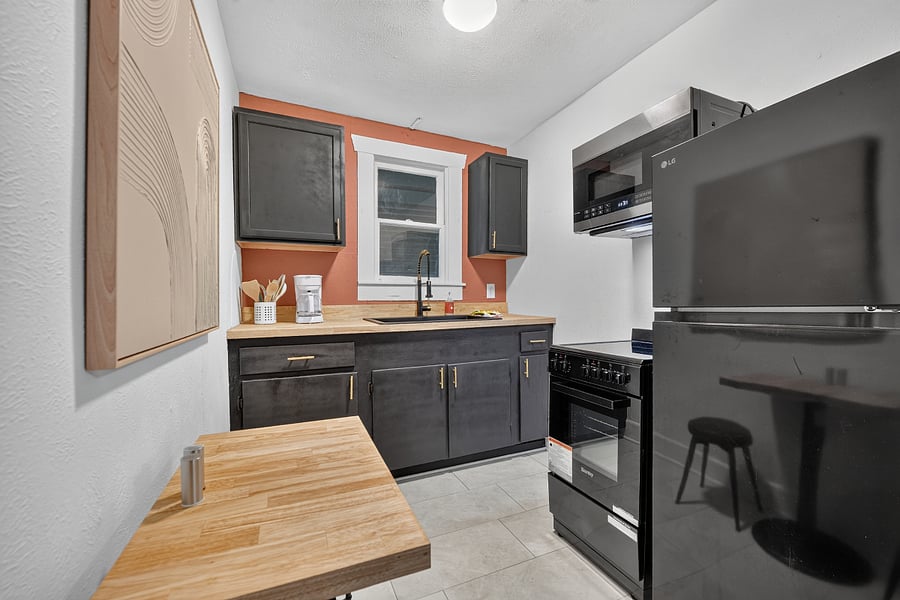 Kitchen + Breakfast table + Fridge + Stove + Oven + Microwave