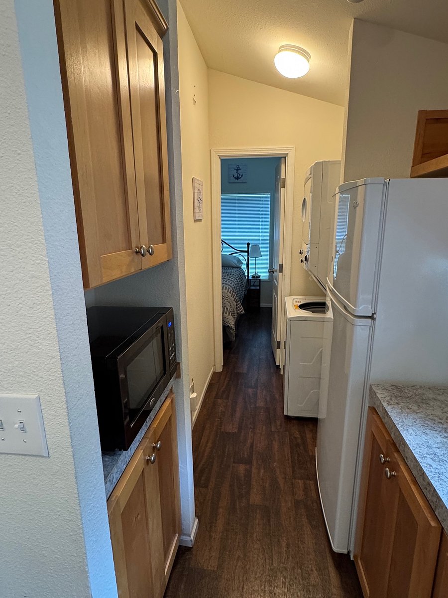 Hall from kitchen to bathroom and bedroom, with washer and dryer