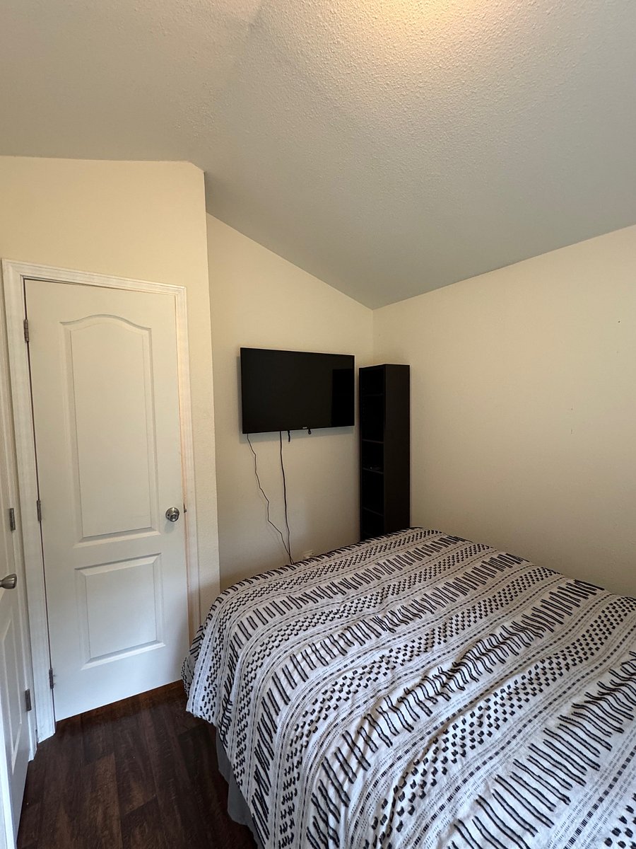 Smart tv and small bookcase in bedroom