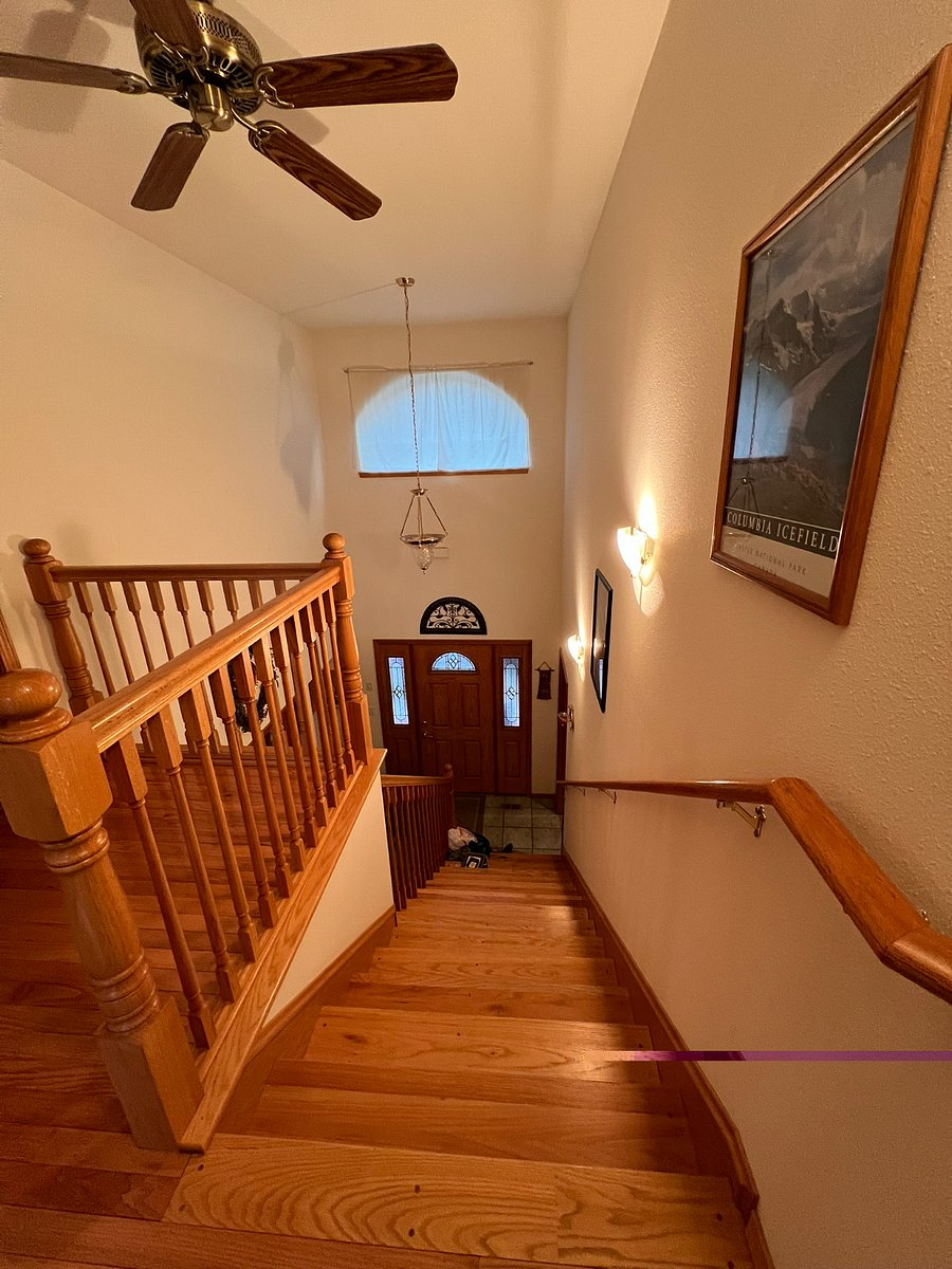 Stairs from front entry to upstairs bedrooms and bathroom