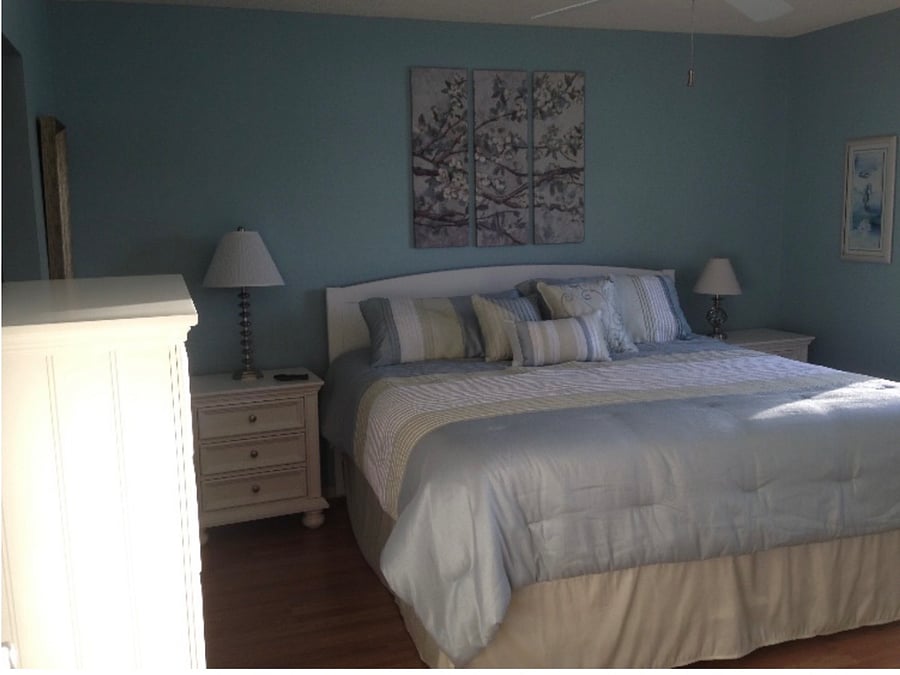 Master bedroom w/ king size bed, bureau, and 2 night stands