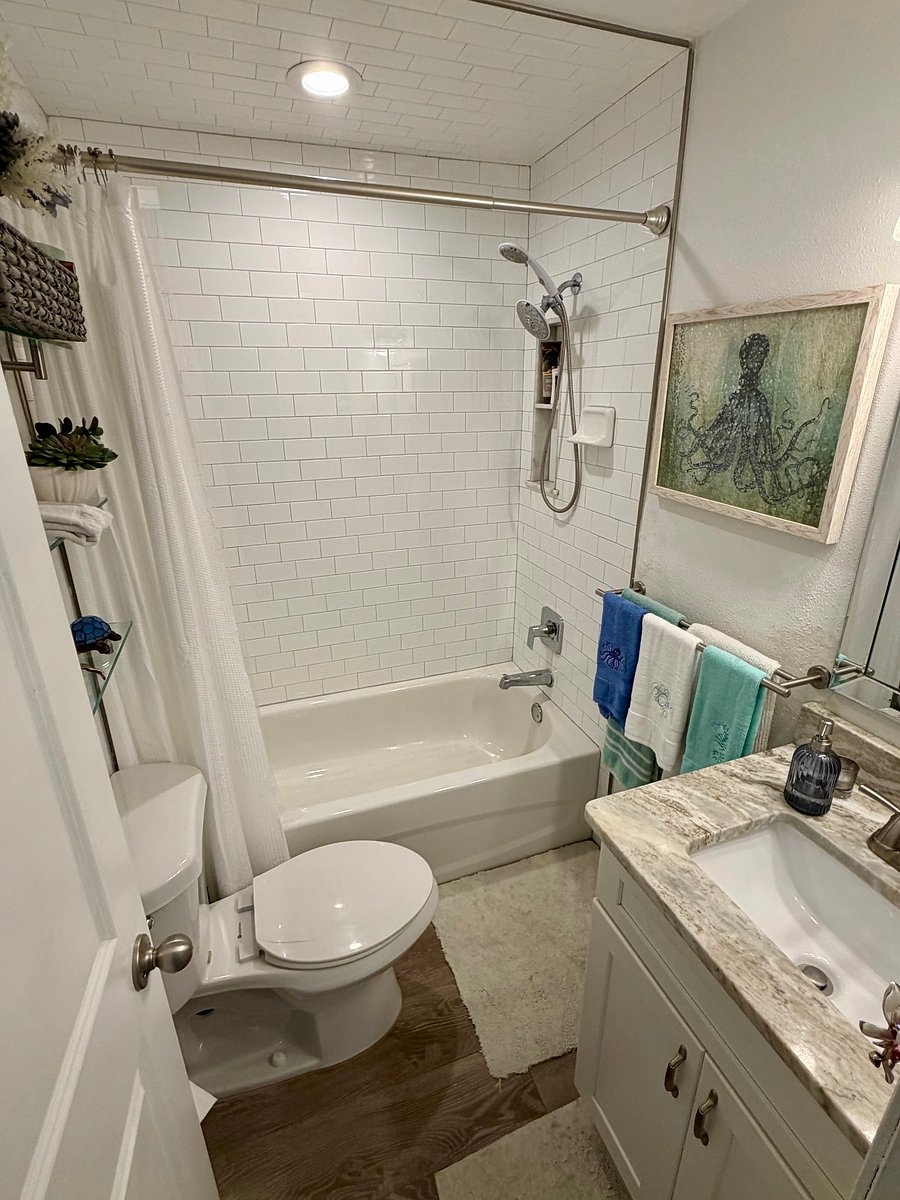 Bright coastal bathroom with white subway tile in shower/shower ceiling