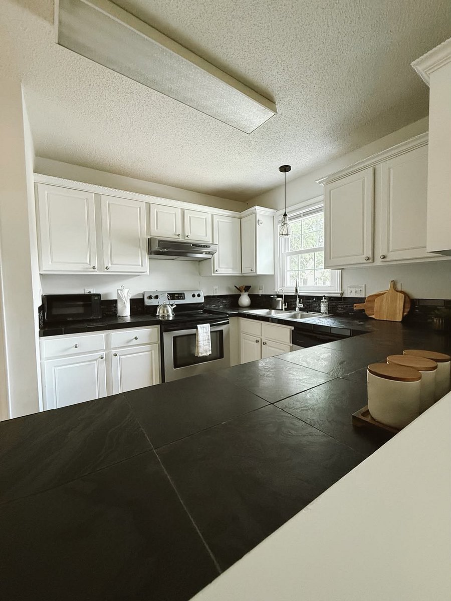 Open kitchen with viewing wall to living room