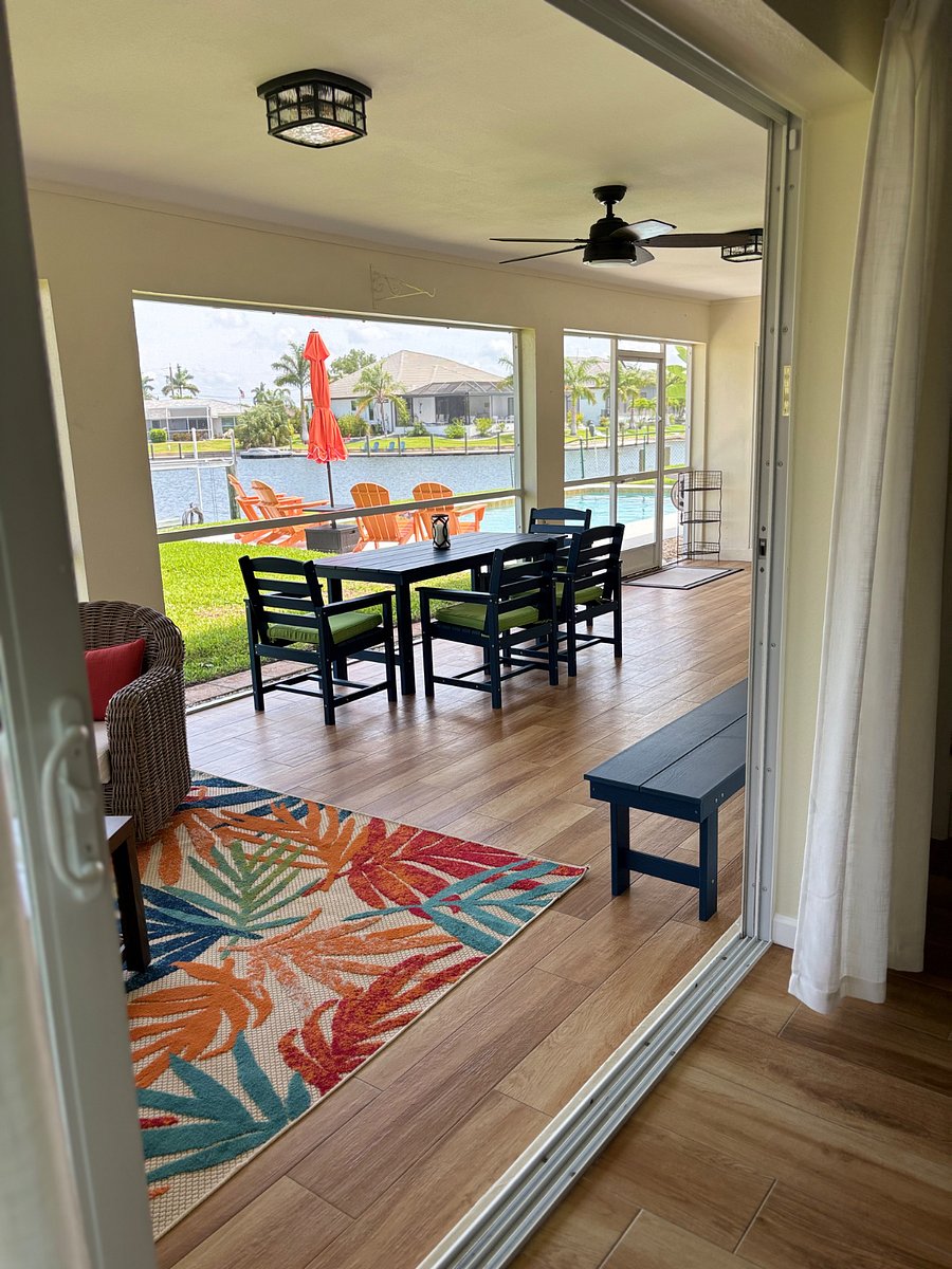 Lanai with lounge area with couch and 2 chairs and dining area