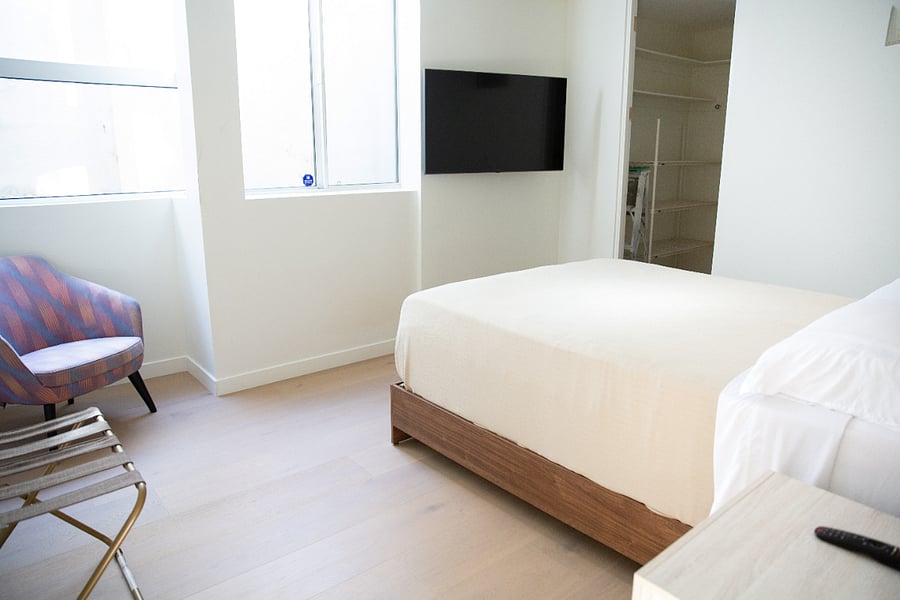 Queen bed and TV in bedroom