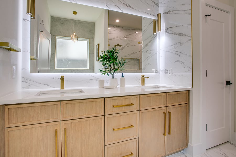 Downstairs primary bathroom with double sink, tub and luxury shower.