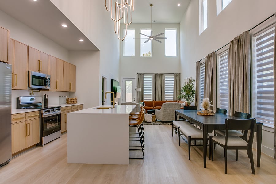 Two story living room, dining room and kitchen.