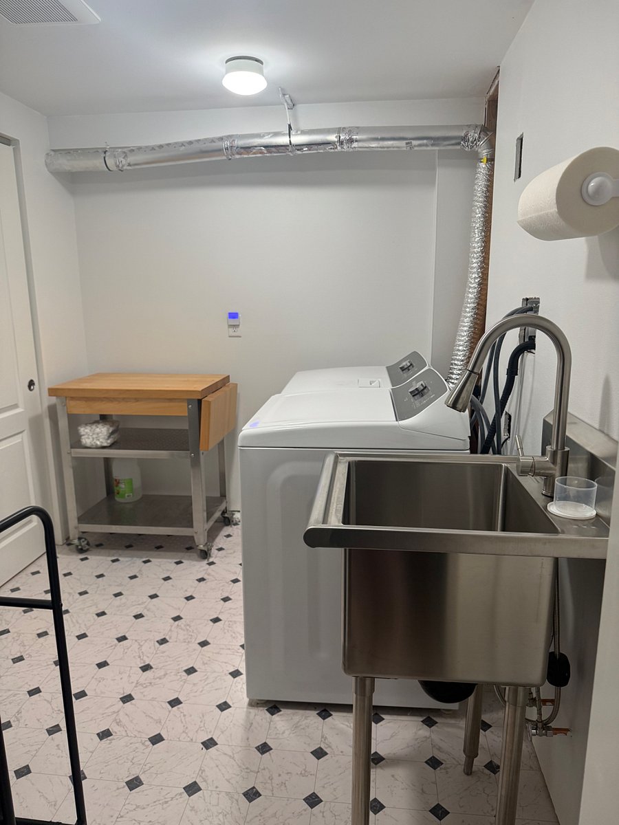 Full-sized private laundry with utility sink