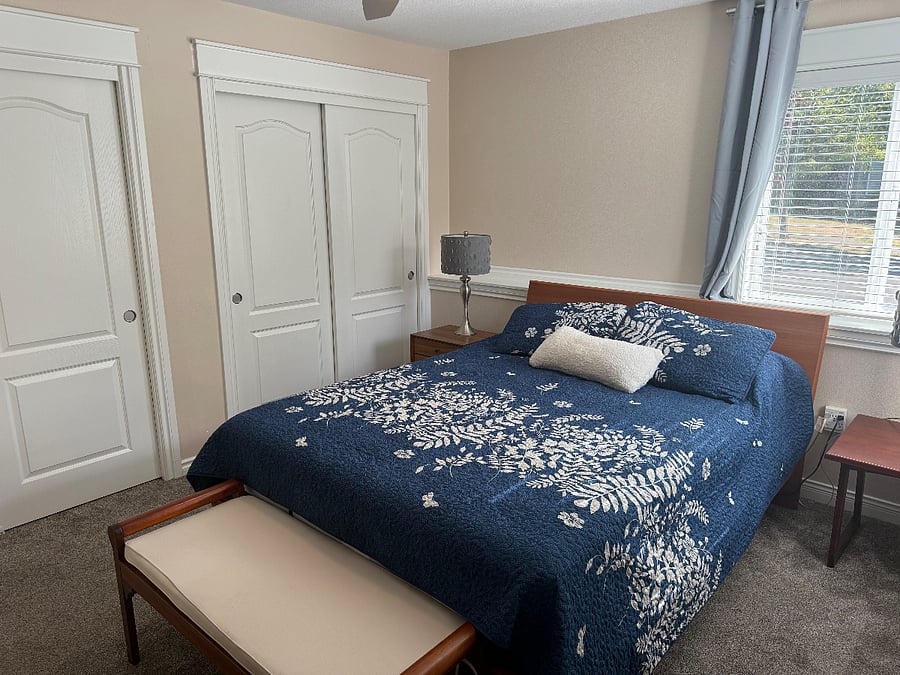 Bedroom with adjustable queen bed, dresser, closets and black-out-drapes.