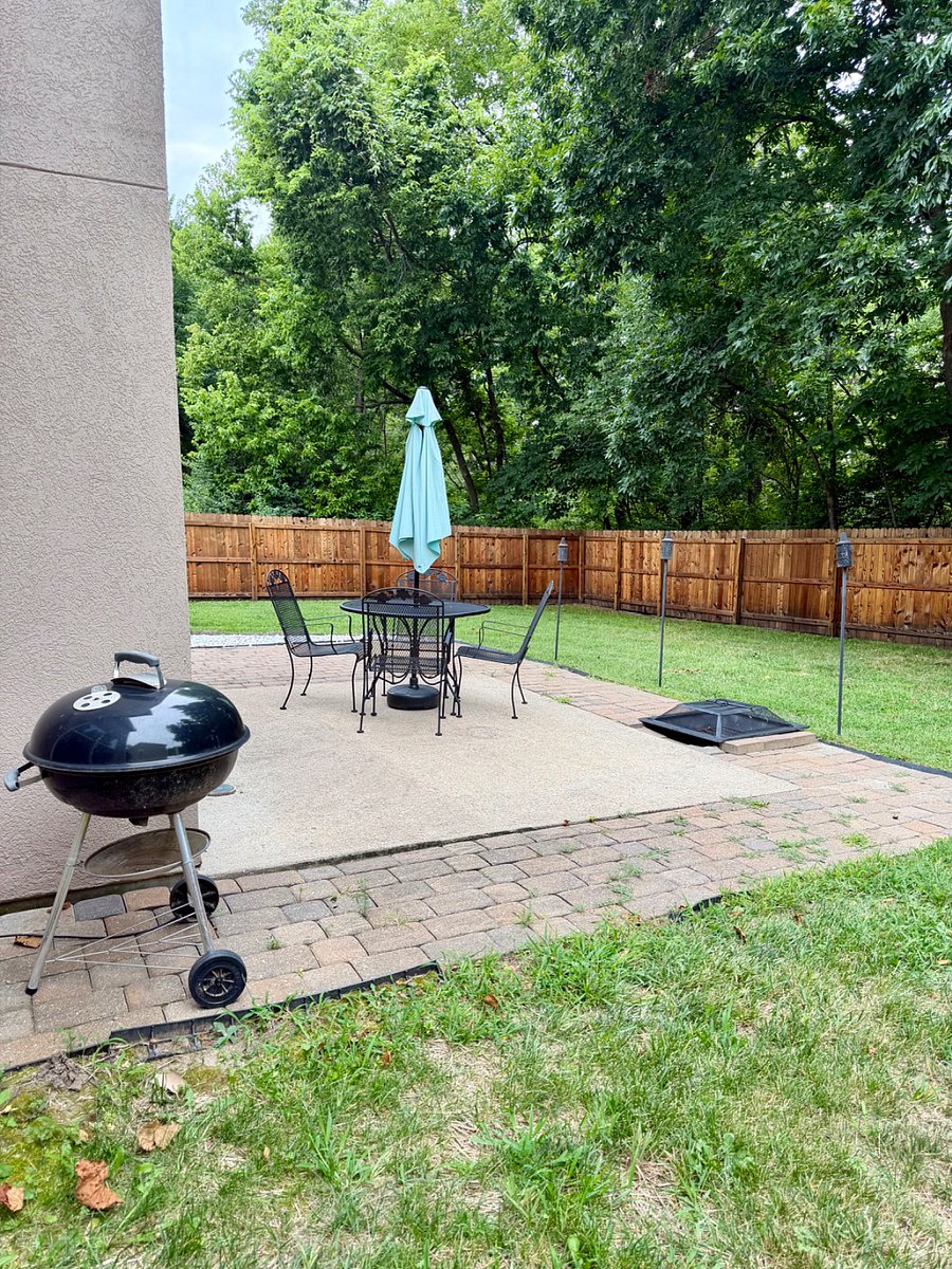 Weber charcoal grill in backyard