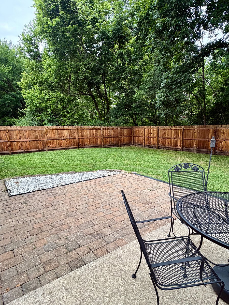 Fully fenced backyard with patio