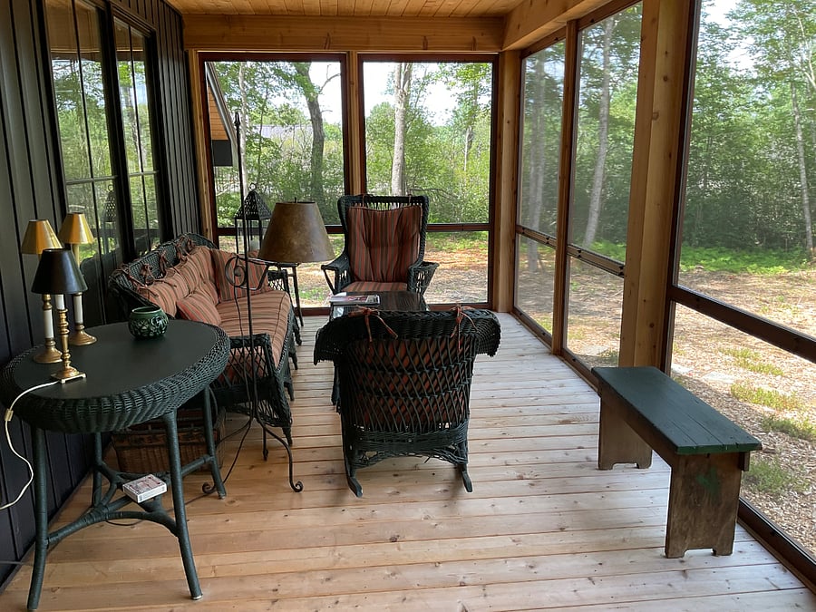 Screened in porch overlooking vegetable garden & orchard.