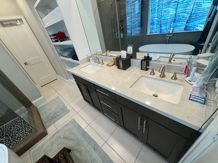 Master bedroom en-suite master bathroom with double vanity, large mirror, medicine cabinet, large shelving