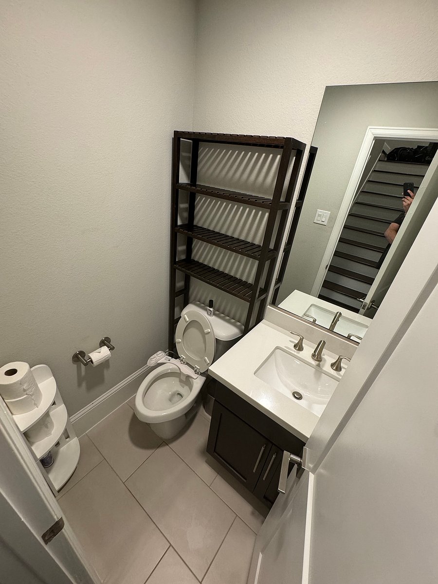 Living/dining/kitchen adjacent half bathroom with bidet-equipped toilet
