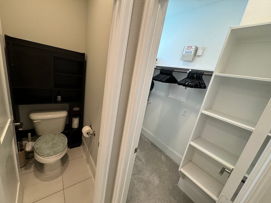 Master bedroom en-suite master bathroom bidet-equipped toilet and over toilet storage