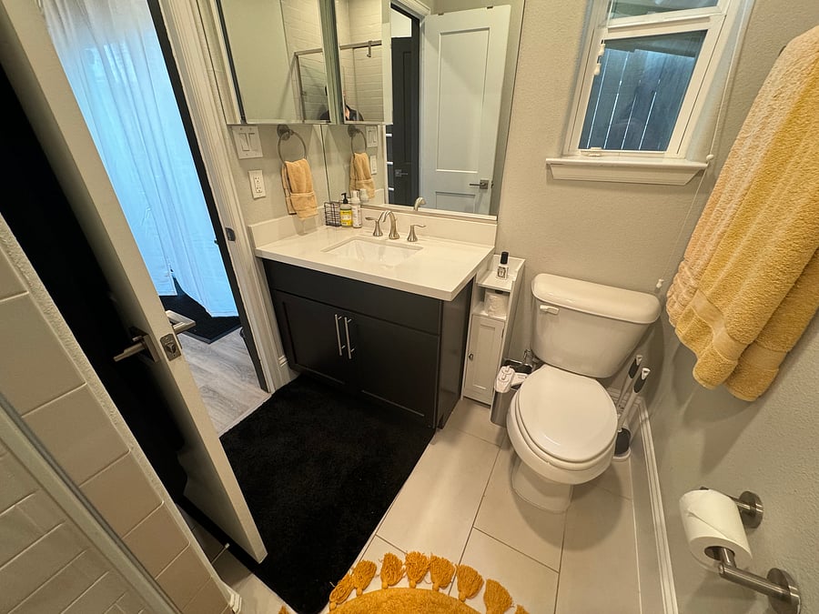 Ground floor bedroom en-suite bathroom with walk-in shower, medicine cabinet, and bidet-equipped toilet