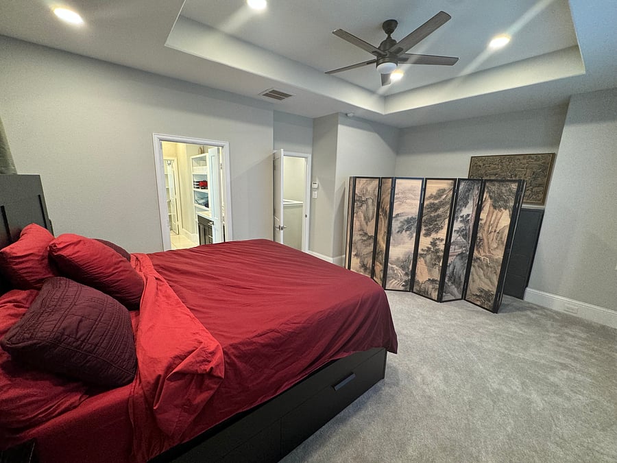 Master bedroom king sized bed with under bed storage drawers, headboard with storage, and nightstands