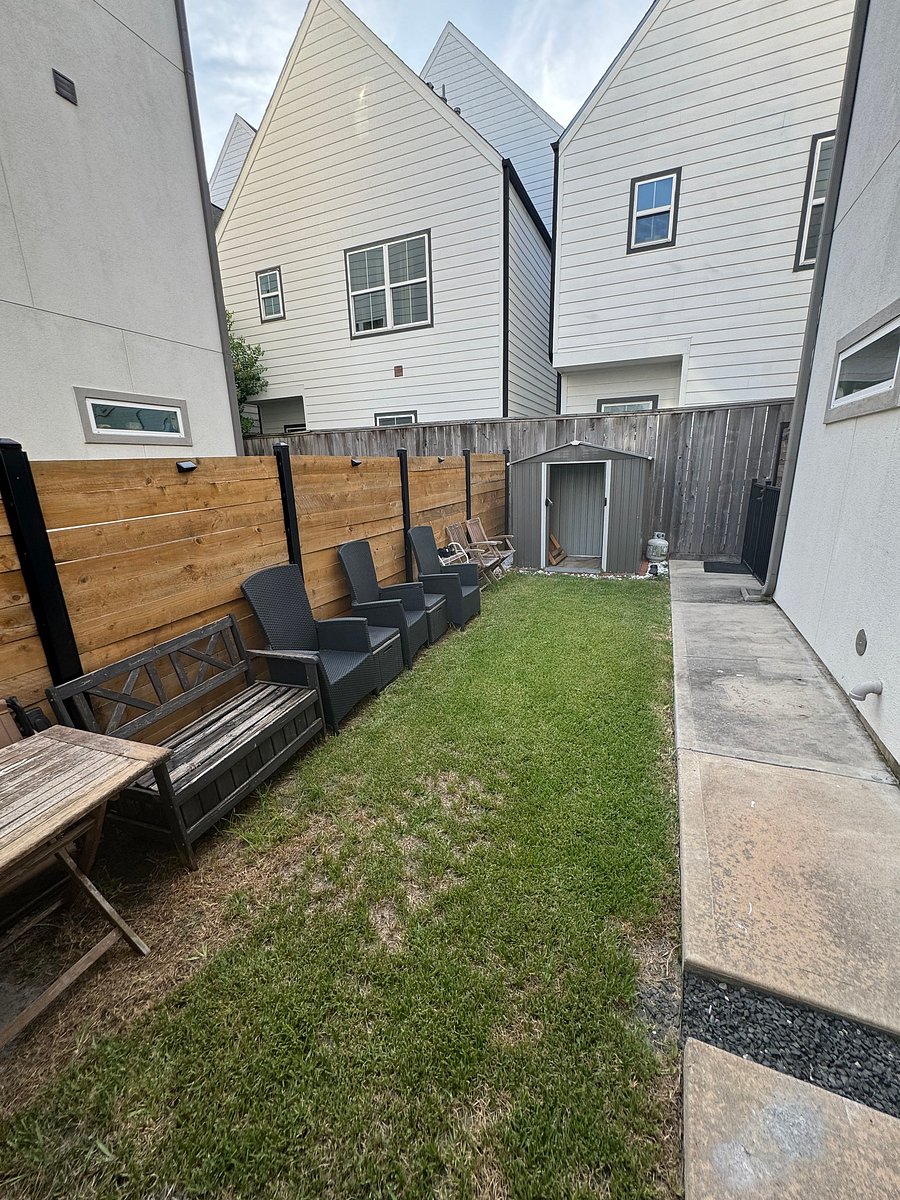 Side yard with yard furniture and storage shed