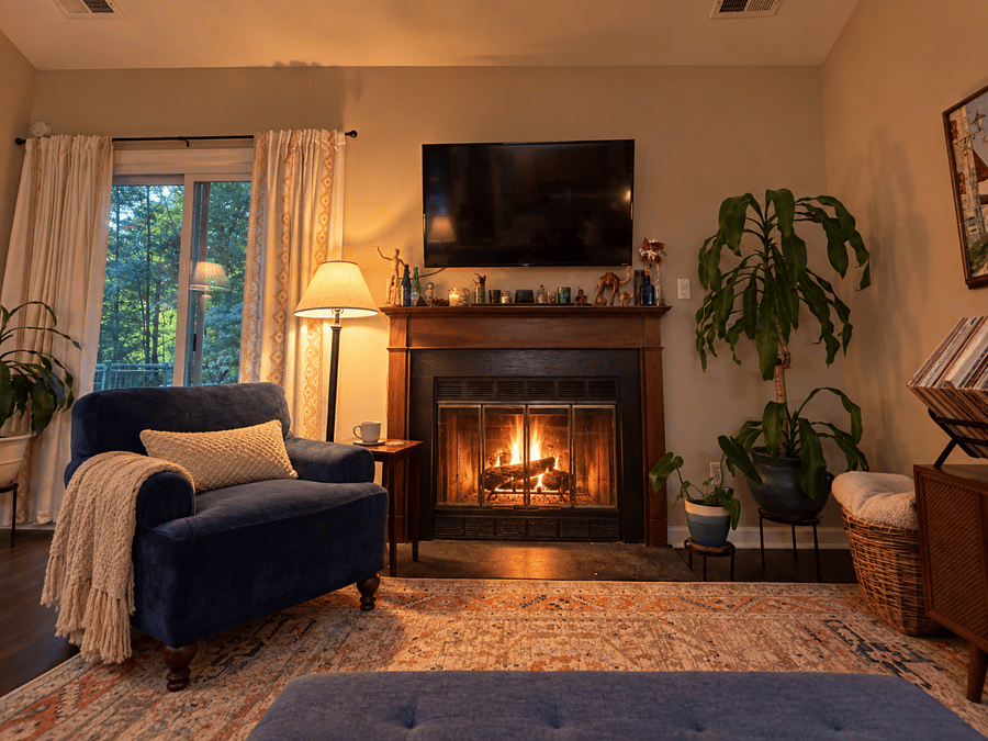 Living room with TV, record player,(also a blue tooth speaker), and the gas fireplace.