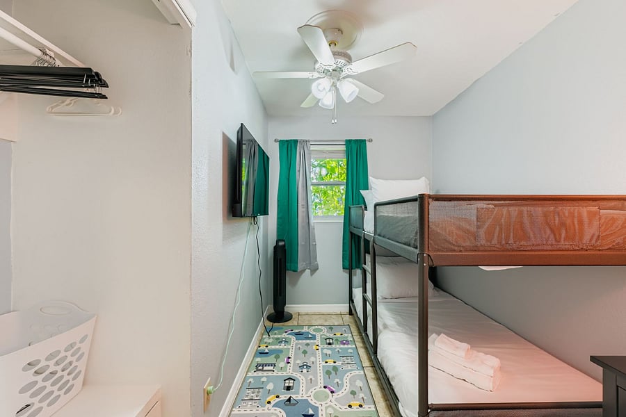 Kids room with twin bunk bed and smart TV