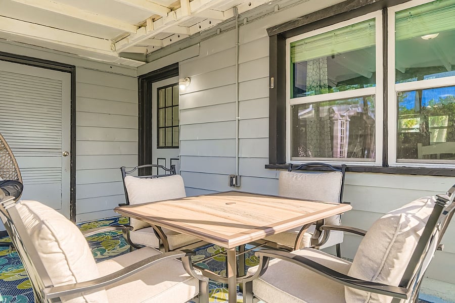 Screened lanai with table and chairs.