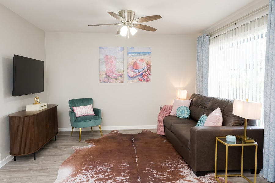 This vibrant living space combines modern entertainment with a touch of southwestern charm, with a large flat-screen TV.