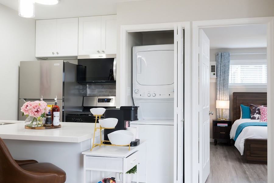 In-unit washer and dryer tucked away in this bright, modern space, located right off the sleek kitchen.