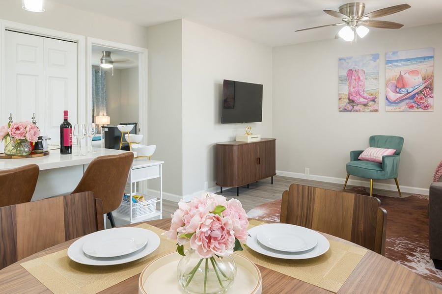 Open-concept living area blends rustic charm with modern comfort, featuring elegant wood dining furniture.