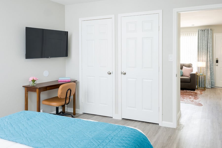 Stay productive or entertained in this versatile space, featuring a classic wooden desk with a comfortable leather chair and a flat-screen TV.