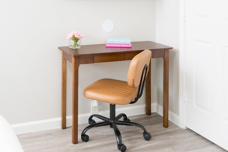 Quiet work nook, thoughtfully accented with fresh flowers for a serene productivity corner.