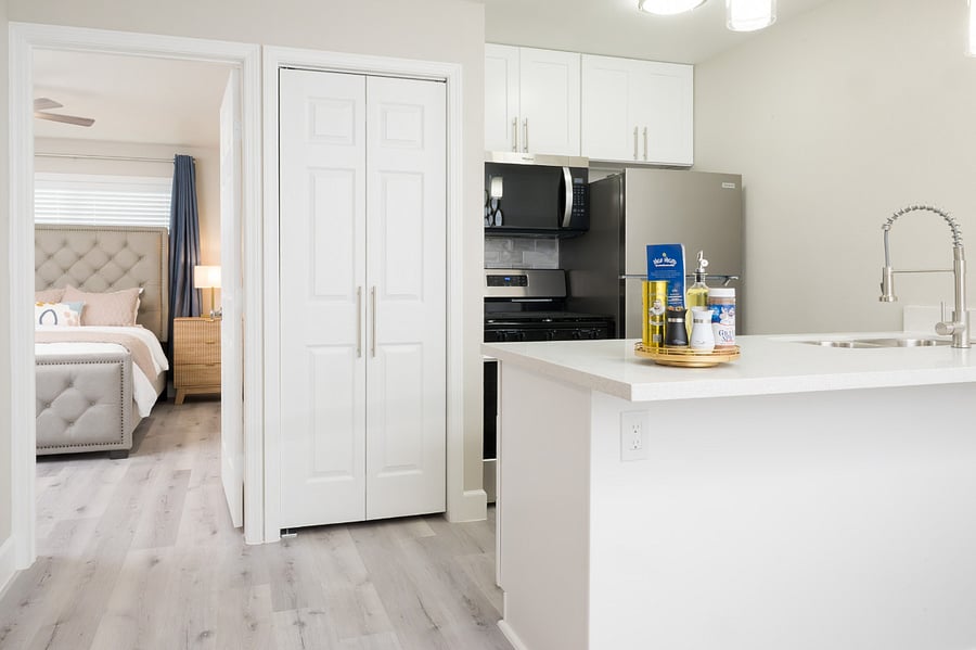 Elegant minimalist interiors featuring crisp white tones and premium stainless steel appliances.