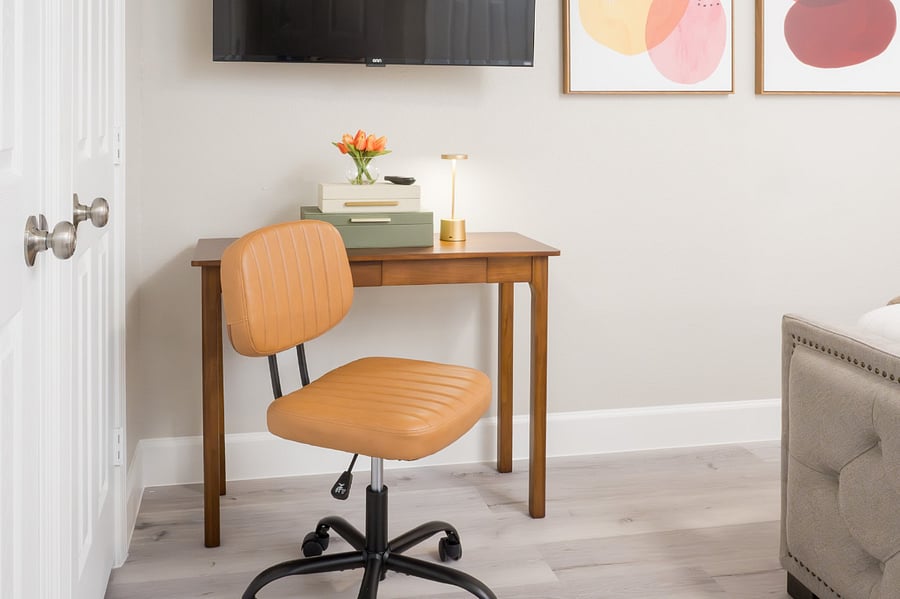 Minimalist desk setup paired with integrated entertainment and stylish furniture.