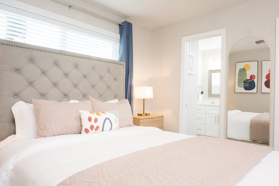 Spacious layout featuring a full-length gold-framed mirror.