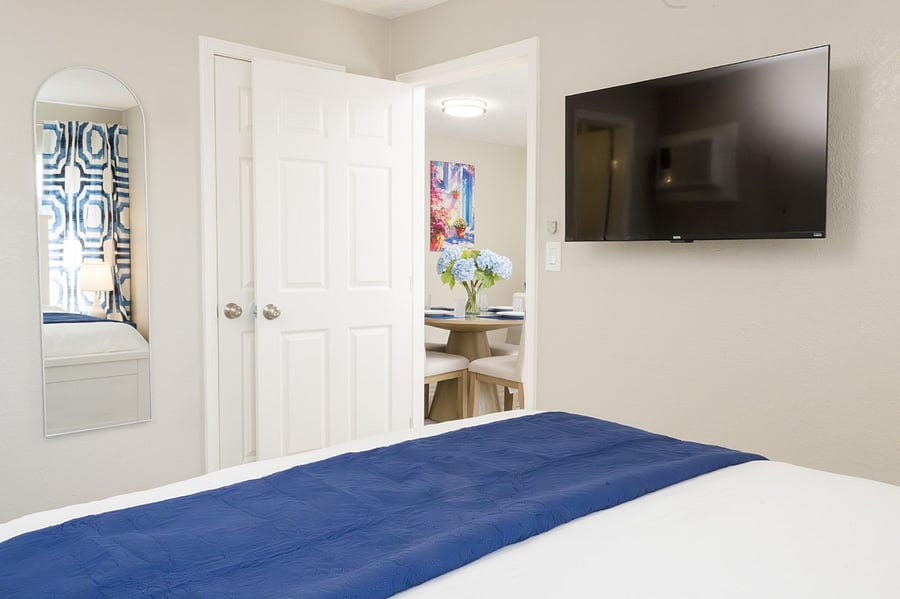 Enjoy movie nights from the comfort of your bed with this sleek wall-mounted TV.
