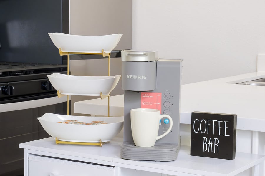 Start your morning right at this dedicated coffee bar, featuring a modern brewer and a variety of coffee pods.