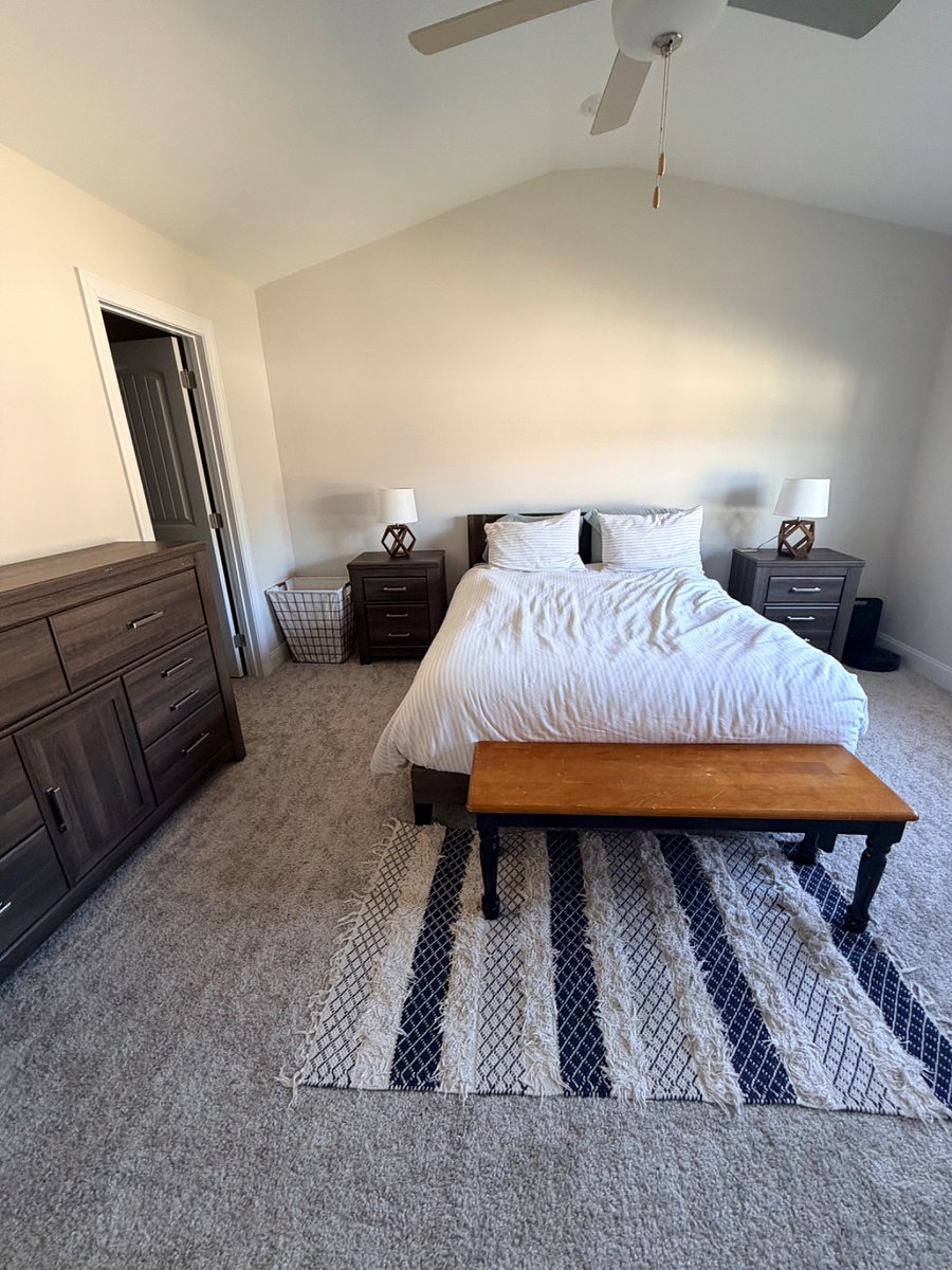 Master bedroom with walk in closet and TV mount on wall on third floor
