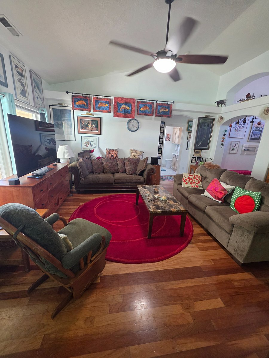 Living room with 65" television flat screen with Direct TV and internet connection for streaming.